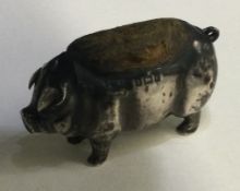 A small silver pin cushion in the form of a pig.