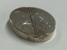An engraved silver double-opening hinged pill box.