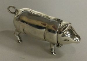 A silver hinged pig box with match striker.
