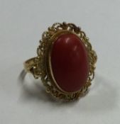 A heavy 18 carat gold coral mounted ring.