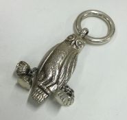 A Sterling silver rattle in the form of an owl.