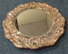 A large chased silver mirror. Sheffield 1902.
