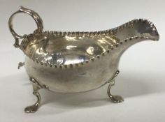 A Georgian silver sauce boat with hammered border.