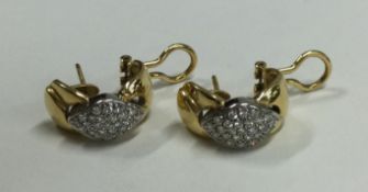 A heavy pair of 18 carat gold diamond set ear hoops.