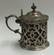 A pierced Victorian silver and glass mustard pot.
