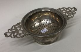 A silver tea strainer on stand. Birmingham.