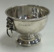 A silver Monteith bowl with lion mask handles.