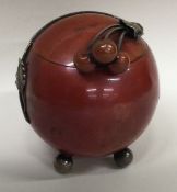 A stylish silver mounted and enamelled inkwell in the form of a fruit with berry finial.