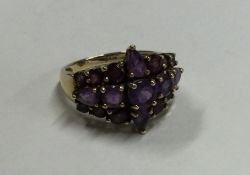 A large amethyst three row ring in 9 carat setting.