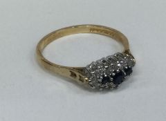 A good sapphire and diamond oval cluster ring in gold mount.