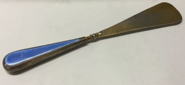 A large silver and blue enamelled shoe horn.