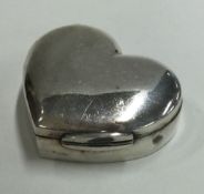 A heart-shaped silver pill box with hinged lid.