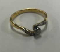 An 18 carat gold diamond crossover ring in claw mount.