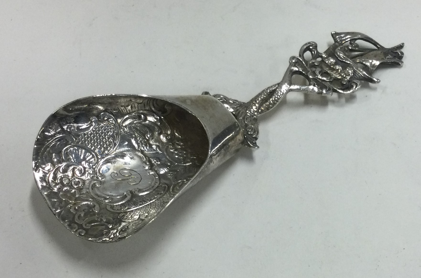 A Continental silver chased caddy spoon. - Image 2 of 2