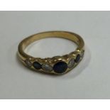 An 18 carat gold sapphire and diamond seven stone half hoop ring.