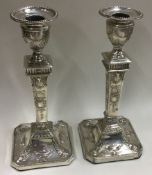 A pair of Neoclassical silver candlesticks.