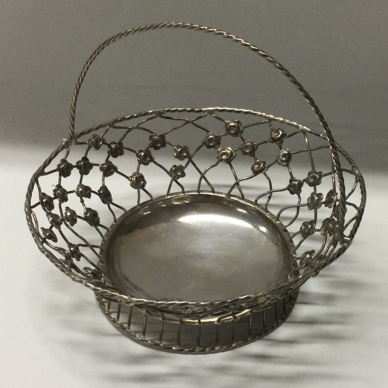 An 18th Century silver swing handled pierced basket.