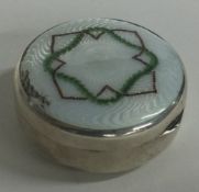 A silver and white enamelled box bearing import marks.