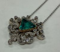 A large Art Deco emerald and diamond pendant with
