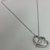 A heavy 18 carat gold diamond heart pendant on fine link chain.