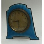 A silver and blue enamelled clock.