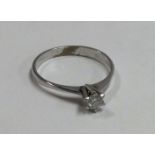 A small diamond single stone ring in 14 carat gold.
