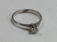 A small diamond single stone ring in 14 carat gold.