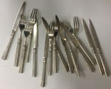 WANG HING: A set of eight (plus eight) silver knives and forks.