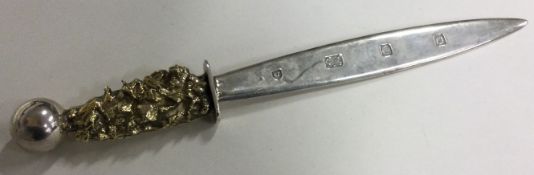 A fine silver and silver gilt letter opener with chased decoration.