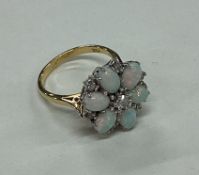 An attractive opal and diamond seven stone cluster