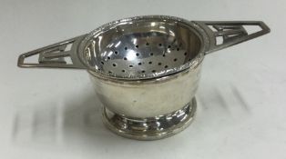 A silver tea strainer on stand. Birmingham.