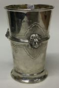A chased silver beaker embossed with lions. Birmingham 1934.