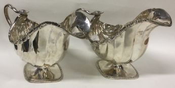 A fine pair of Victorian silver sauce boats with serpent handles.