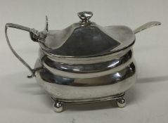 A Georgian silver and glass mustard pot and spoon.