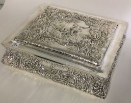 A large chased silver jewellery box with embossed decoration.