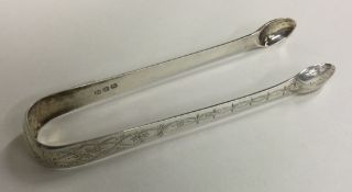 A good pair of Georgian silver sugar tongs. London.