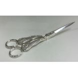 A good pair of William IV silver grape scissors with shell decoration. London 1837.