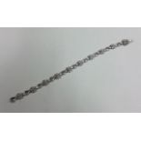 A good 18 carat gold diamond line bracelet with concealed clasp.