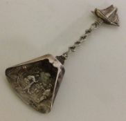 A novelty Continental silver caddy spoon in the form of a shovel decorated with cast ship to handle.