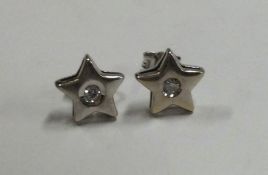 A good pair of diamond star shaped earrings in 18 carat gold mount.