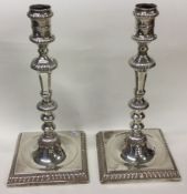 A fine pair of 18th Century Georgian silver candlesticks on square bases.
