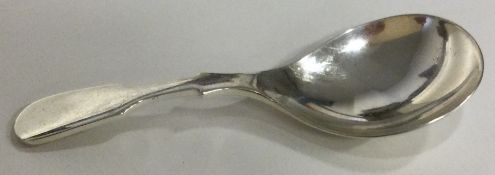 A modernistic silver caddy spoon.