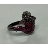 An unusual ruby and diamond mounted ring in the fo