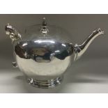 A good George III silver teapot with hinged top on ball feet. London 1736.