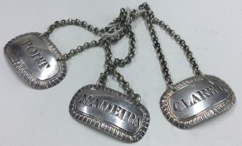 A set of three cast silver wine labels for 'Madeira', 'Port' and 'Claret'.