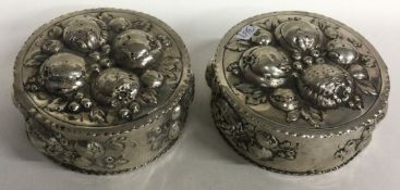 A pair of chased Continental silver Antique boxes.