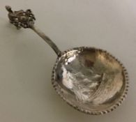 A Continental silver caddy spoon embossed with a shipping scene.