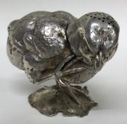 A heavy Victorian silver pepper in the form of a chick.