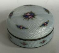 A silver and white enamelled box engraved with flowers bearing import marks.