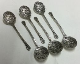 A collection of six Continental silver coffee spoons with dragon decoration.